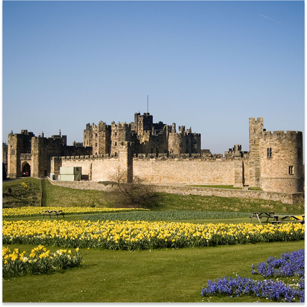 Front facing view of Alnwick Castle from outside the castle gates in the United Kingdom.