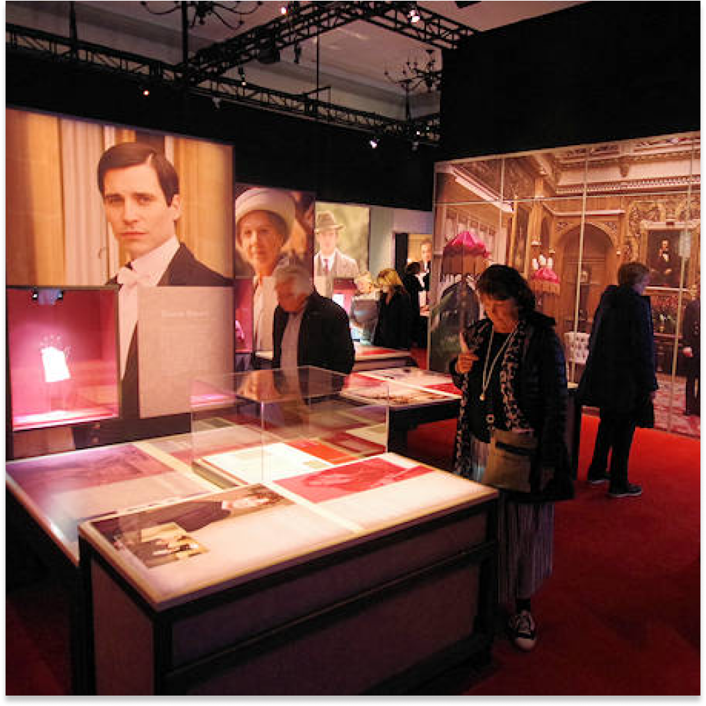 People walking through Downton Abbey: The Exhibition.